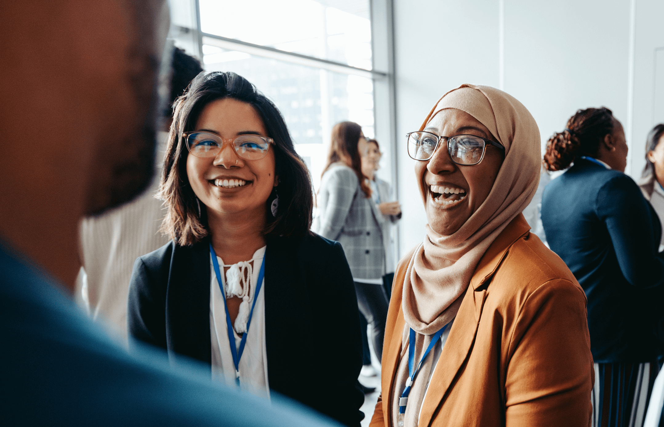  A group of women engaged in a business meeting during a conference, discussing ideas and collaborating.